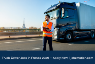 Truck driver standing next to a large semi-truck on a French highway, representing truck driver jobs in France 2026 with visa sponsorship | jobzmotion.com